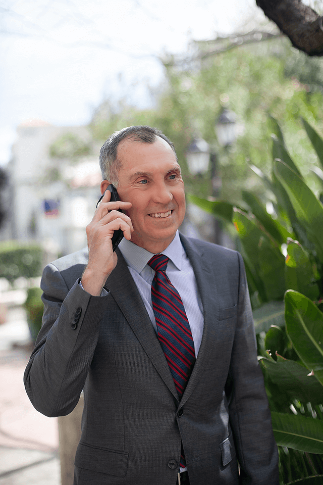 IMG_7575 Robert P. Erbe, an attorney for federal employees, talking on the phone outside of his Tucson law office.